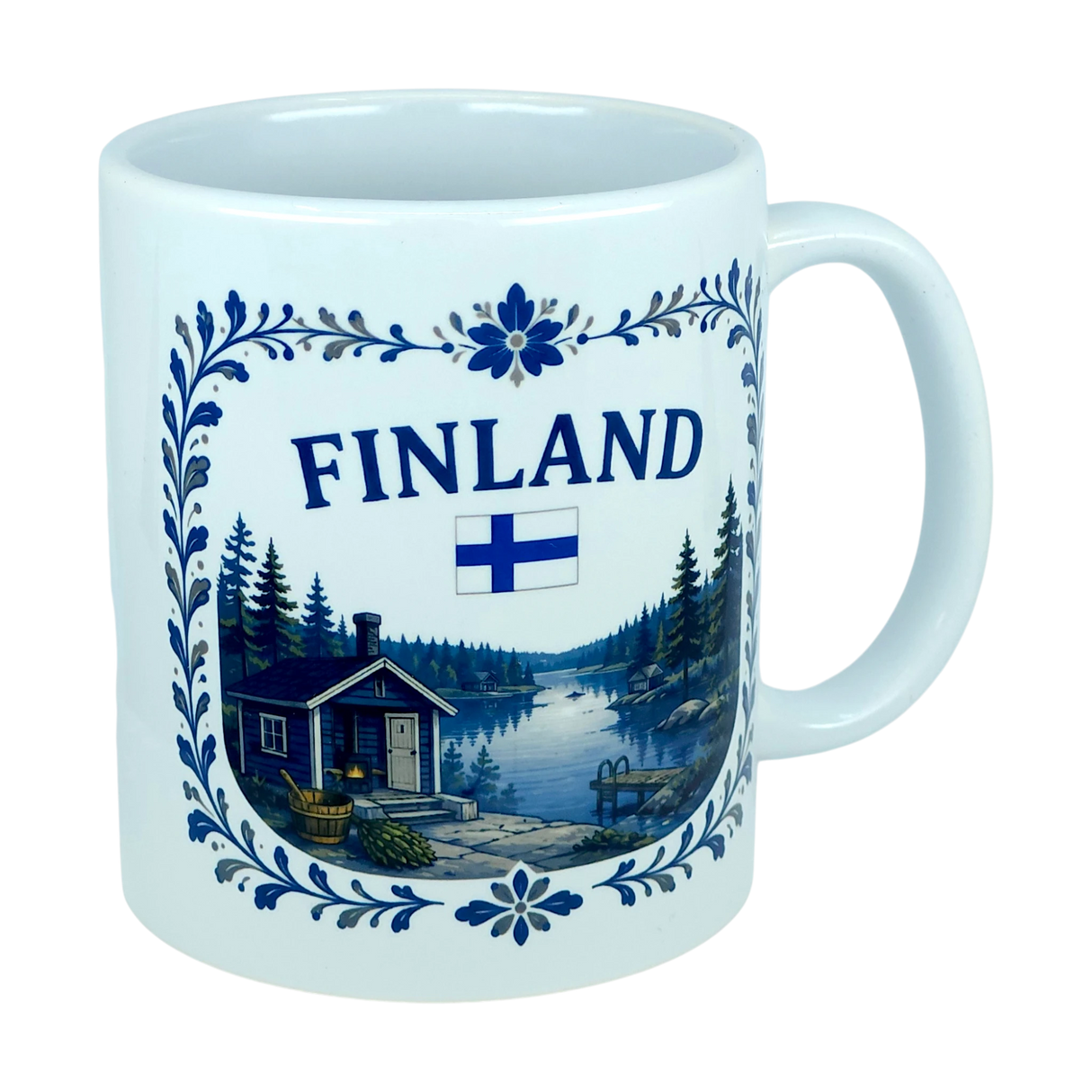 Introducing the Mug: Finland Lakeside Cabin Ceramic Mug (11 oz Capacity) by Nordic Wholesale—a white Finnish ceramic mug adorned with a scenic illustration of a Nordic lakeside cabin surrounded by trees, featuring a Finnish flag and decorative blue floral patterns. This mug makes an ideal gift for celebrating Finnish heritage.