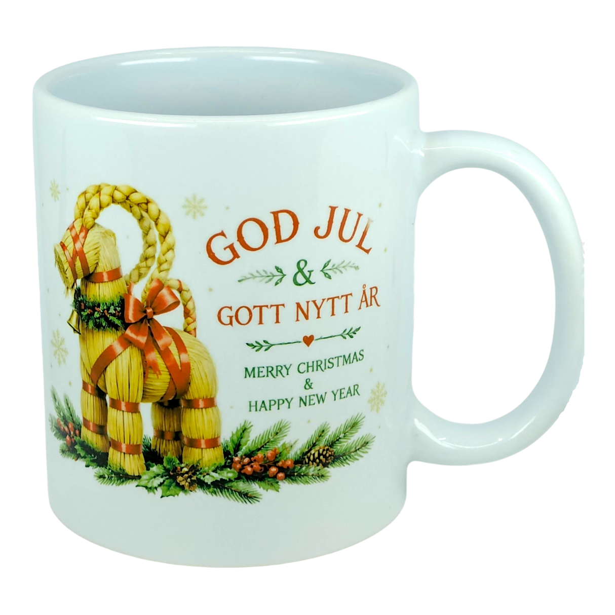 The Nordic Wholesale Mug: God Jul Yule Goat Ceramic Mug (11 oz Capacity) is a white mug decorated with a traditional Swedish Julbock—the straw Scandinavian Yule Goat—embellished with red ribbons and festive greenery. The mug features the greeting "God Jul & Gott Nytt År" in Swedish and its English translation, "Merry Christmas & Happy New Year.