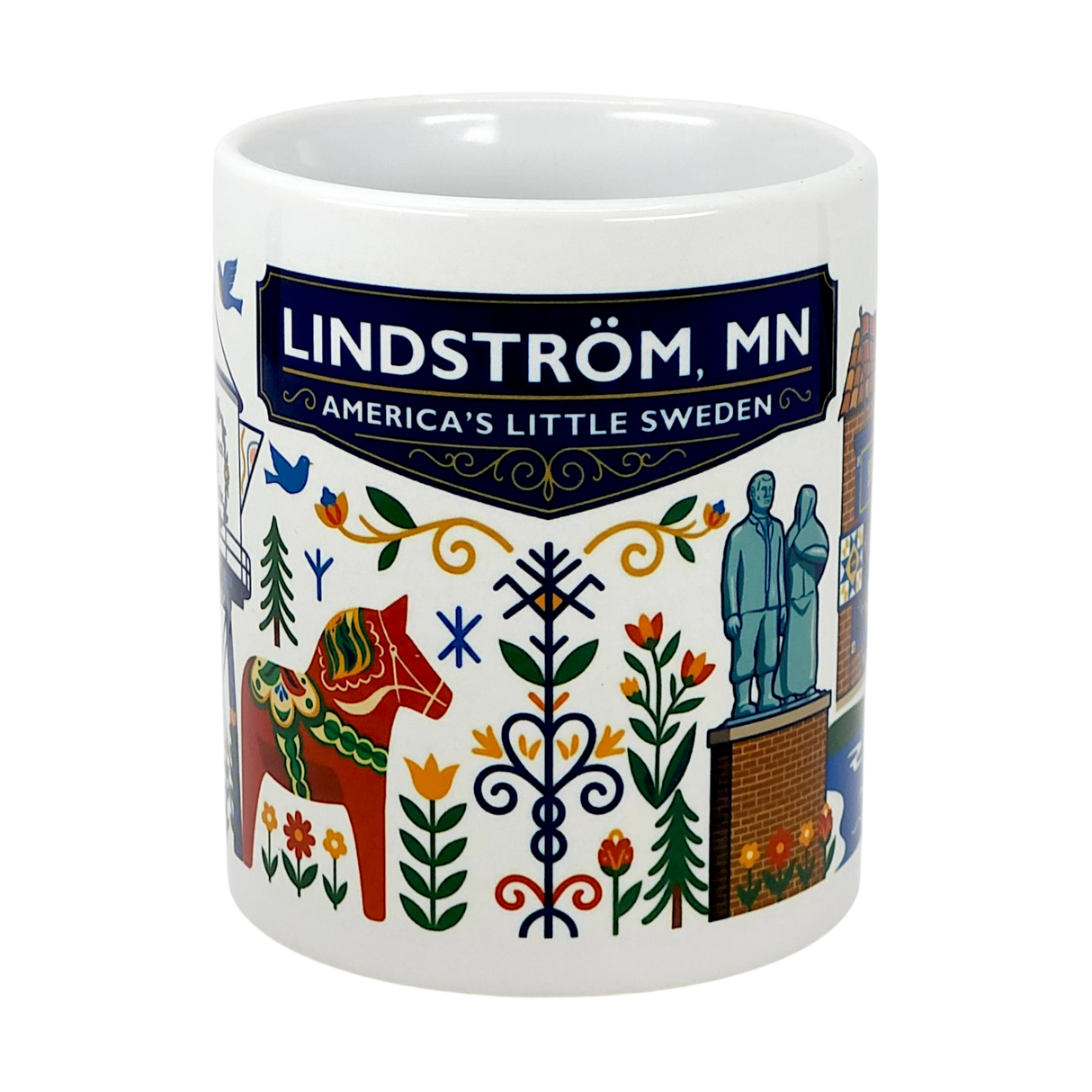 The Swedish Gift Store's 11oz Lindstrom, MN — America's Little Sweden mug features vibrant Scandinavian folk art, a Dala horse, landmarks, and "Lindström, MN" on a blue banner—an ideal ceramic souvenir or Swedish-themed gift.