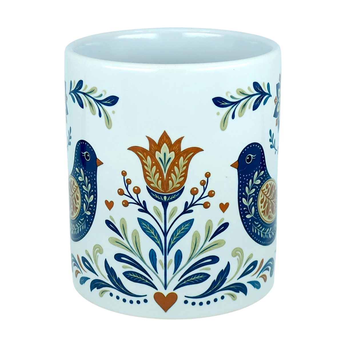 Introducing the Mug: Nordic Folk Art Birds Ceramic Mug (11 oz Capacity) by Nordic Wholesale—an elegant white ceramic mug adorned with a symmetrical folk art motif featuring two blue birds, a central orange and yellow flower, leafy accents, and delicate orange hearts. Ideal for anyone who loves the timeless appeal of Scandinavian design.