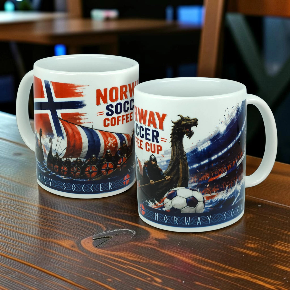 Two white mugs from Swedish Gift Store rest on a wooden table, each adorned with Norway flags, Viking longships, dragons, and dynamic soccer stadium scenes. Bold red and blue "Norway Soccer Coffee Cup Mug – Viking Longship Fan Mug" text stands out amid the intricate designs. These charming Norwegian soccer mugs perfectly combine the legendary imagery of Viking longships with football excitement, making them an essential for any fan.