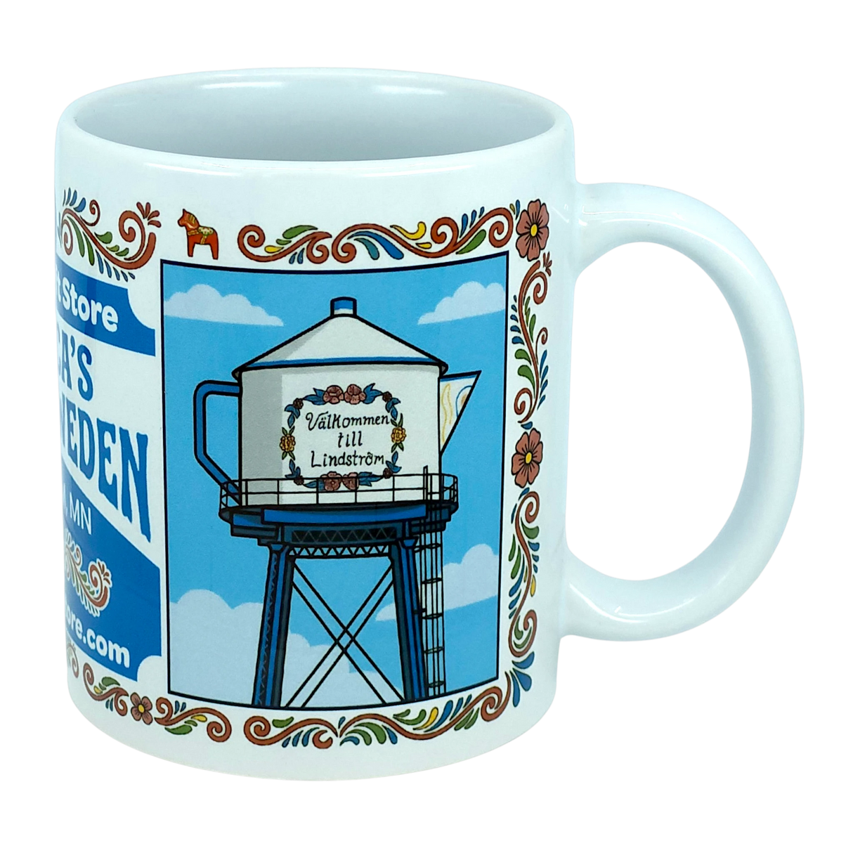 The Nordic Wholesale "Mug: Swedish Gift Store America’s Little Sweden Wraparound Ceramic Mug (11 oz)" features a charming illustration of a teapot-shaped water tower with “Välkommen till Lindström” displayed on it, surrounded by floral borders and set against a blue sky with clouds—a delightful tribute to Swedish-American heritage.