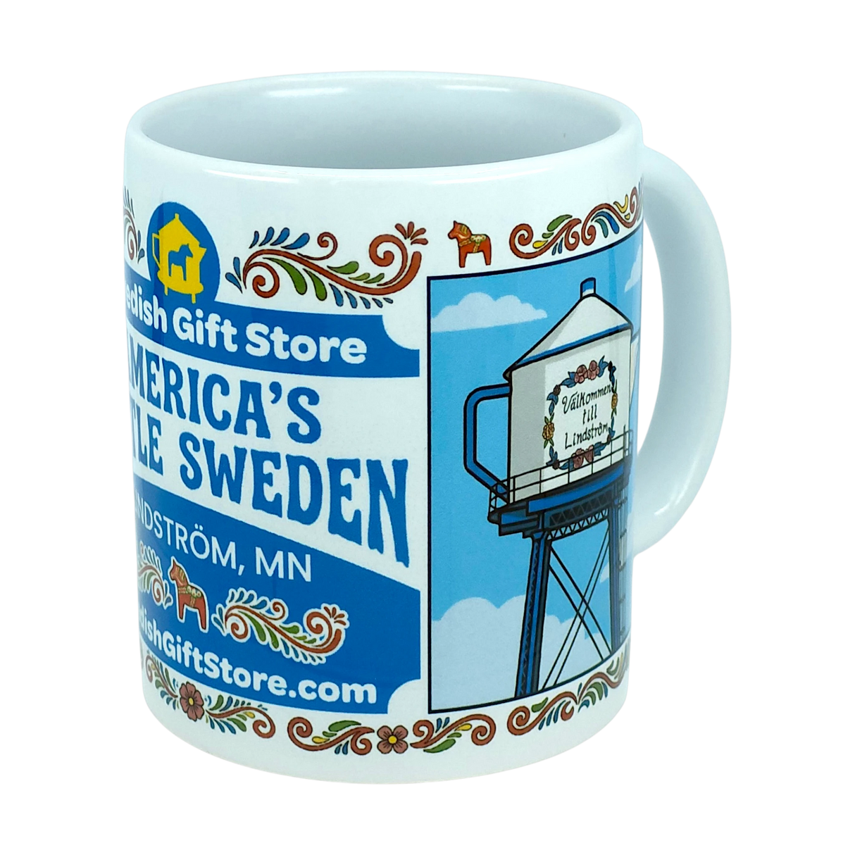 Introducing the Mug: Swedish Gift Store America's Little Sweden Wraparound Ceramic Mug (11 oz) by Nordic Wholesale—a white ceramic mug adorned with Swedish folk patterns, "Swedish Gift Store" text, and a wraparound illustration of a water tower labeled "America’s Little Sweden," celebrating the heritage of Lindström, MN—making it the perfect mug for Swedish-American pride.