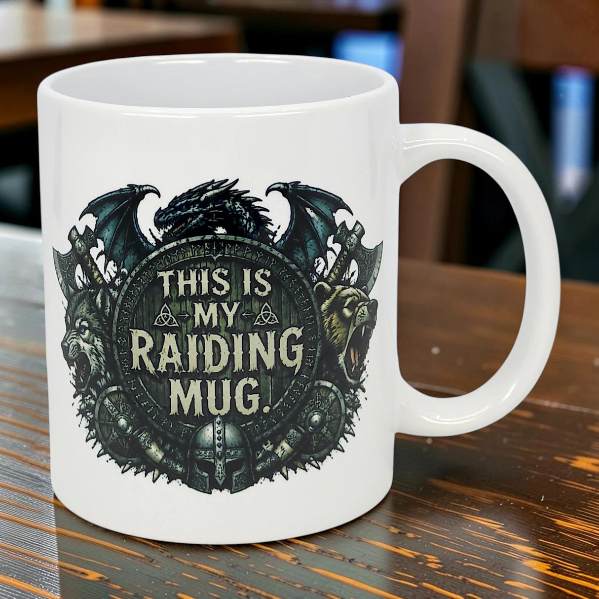 The Nordic Wholesale 11 oz ceramic mug features bold "THIS IS MY RAIDING MUG" text, Norse dragon, bear, wolf, shield, and helmet artwork—a perfect fantasy Viking-themed drinkware choice.