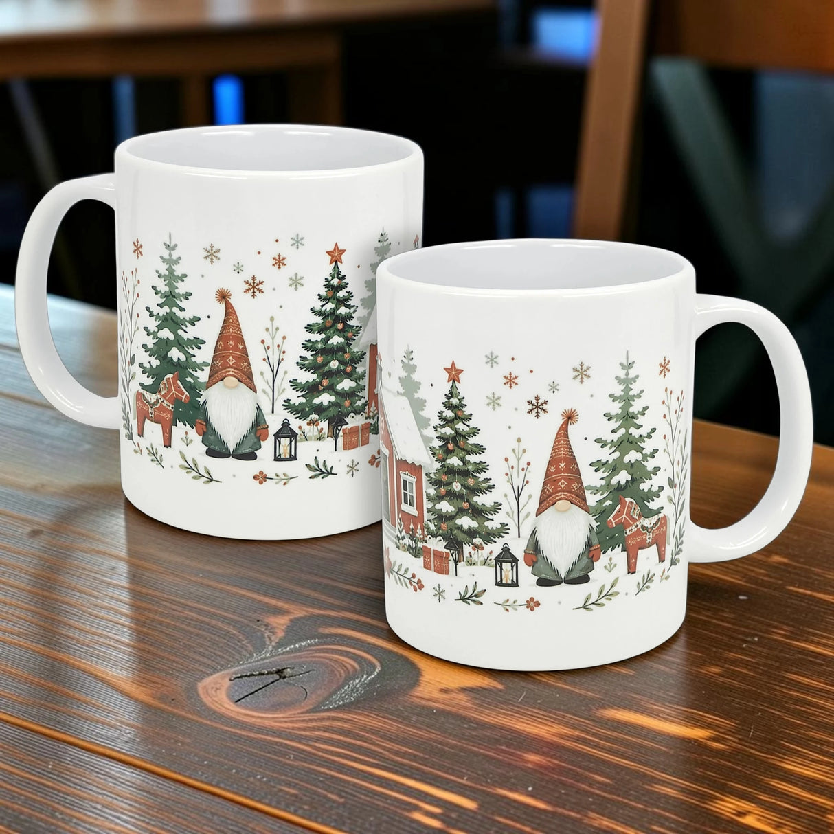 Two Nordic Wholesale "Winter Tomte and Dala Horse" ceramic mugs (11 oz), featuring festive Nordic designs with gnomes, reindeer, lanterns, Christmas trees, and snowflakes, sit on a wooden table.