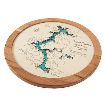 Lake Map: Round Map Green Lake is a round wooden plaque depicting Lake Coeur dAlenes intricately carved waterways and layered map features, with labeled landmarks like St. Joe River and elevation details—ideal for lakeside beauty enthusiasts from Chisago City to Green Lake.