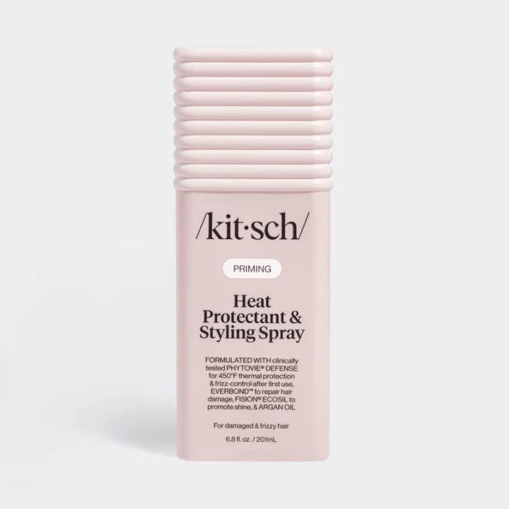 A pink spray bottle with a black pump, labeled “Kitsch,” standing upright on a plain white background.