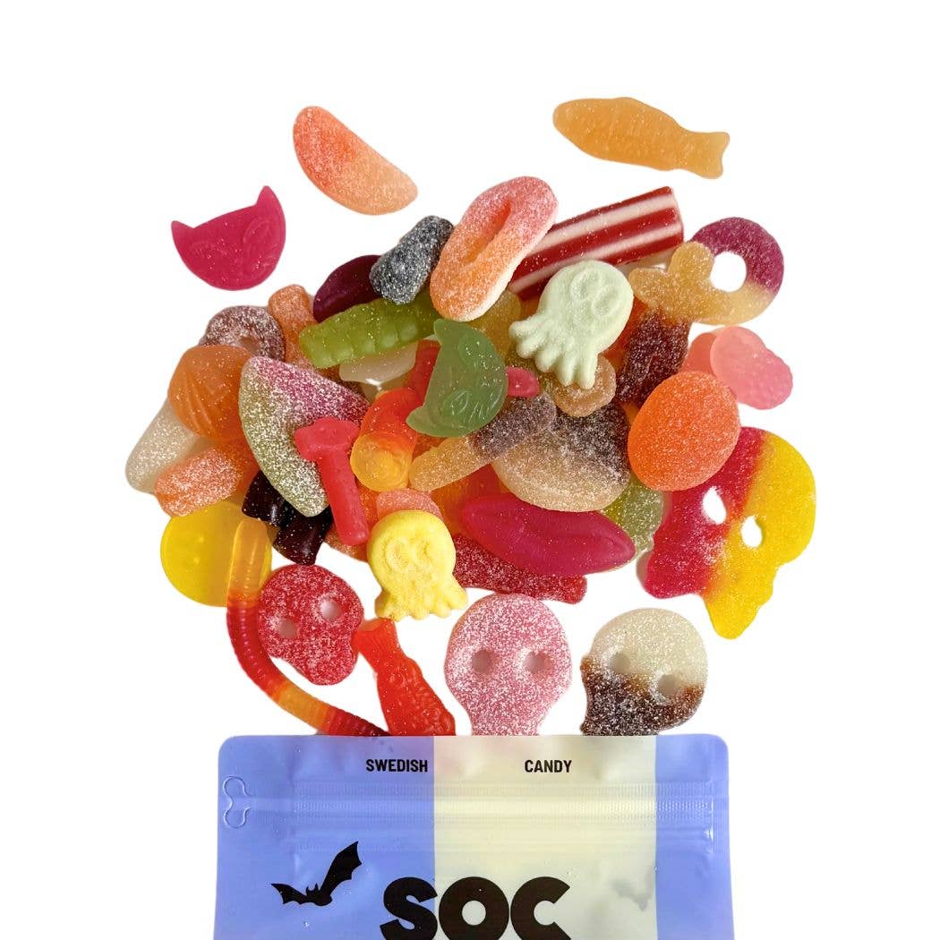 A pile of colorful gummy candies—skulls, worms, and fish—sits atop a blue bag labeled "Candy: Spooky Swedish Gummy Mix 8 oz Bag," making it a perfect Halloween treat or spooky gummy snack.