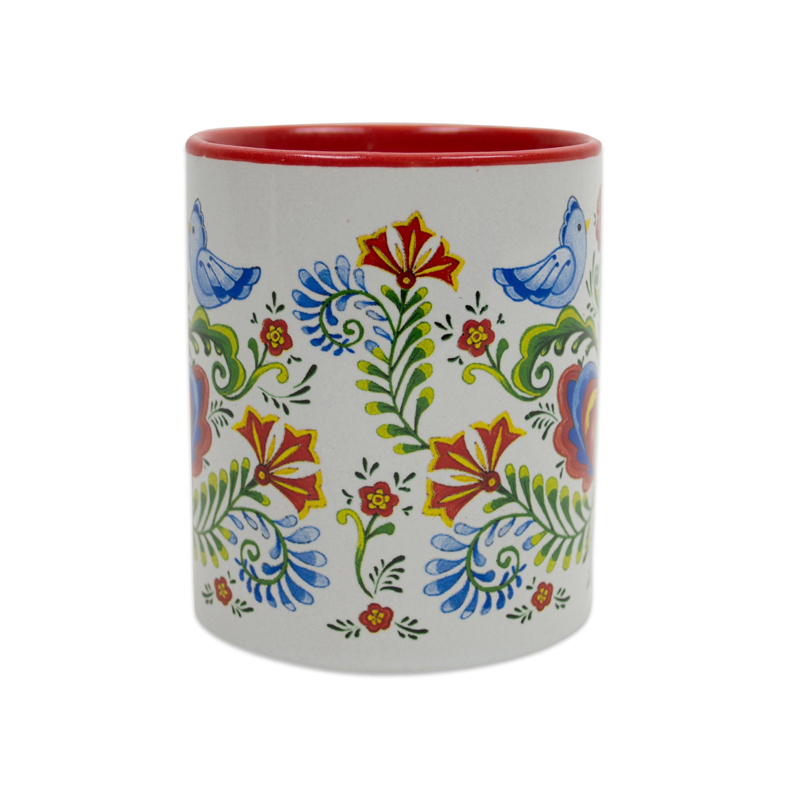 The Mug: Rosemaling & Lovebirds Ceramic Coffee Mug features a white ceramic body, red interior, and colorful blue, green, yellow, and red floral and bird patterns inspired by Scandinavian rosemaling. 12 oz capacity.