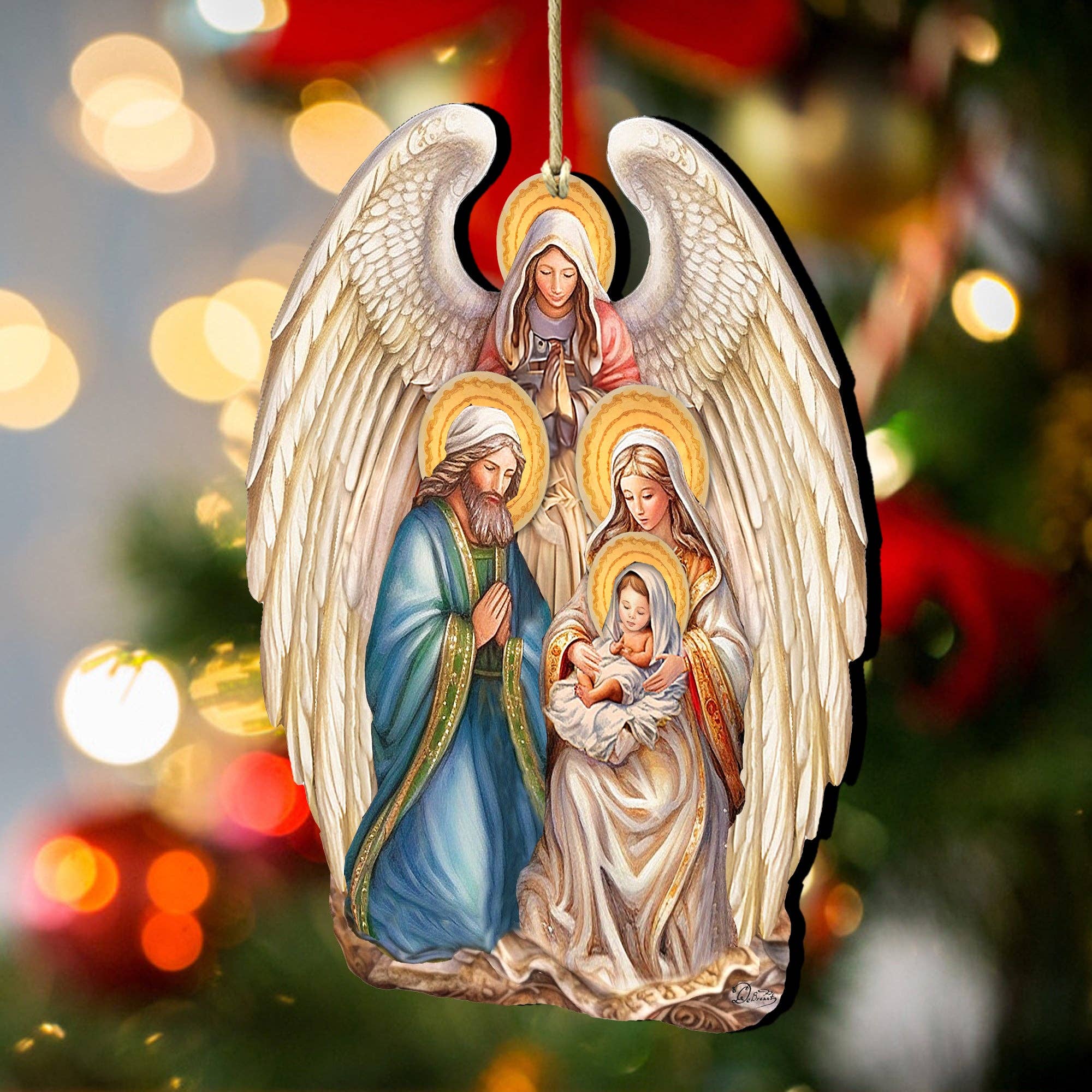 The Ornament: Angel with Nativity Family Wooden Christmas Tree Ornament by G.Debrekht (5x4 inches) features an angel with wings behind Joseph, Mary, and baby Jesus—perfect for hanging on your Christmas tree.