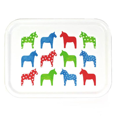 The Tray: "Dalahast" Dala Horse Decorative Tray (3"x11", birch veneer) is made in Sweden and features twelve white stylized horses with hearts, polka dots, and stars in green, blue, and red.