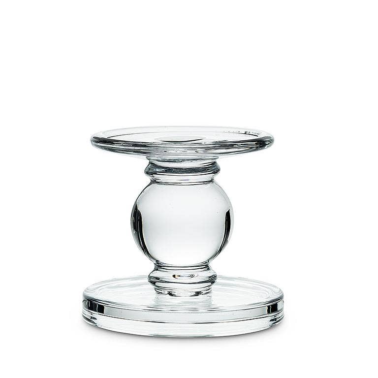 The Candle Holder: Small Reversible Candleholder-2.5"H features a clear glass pedestal with a round top and base, joined by a spherical center—an elegant piece for displaying pillar candles on any tabletop.