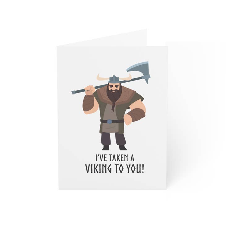 The "I’ve Taken a Viking to You (Male Viking)" greeting card features a cartoon Viking with an axe and the phrase "I'VE TAKEN A VIKING TO YOU!"—a fun Valentine’s Day card, blank inside for your own message.