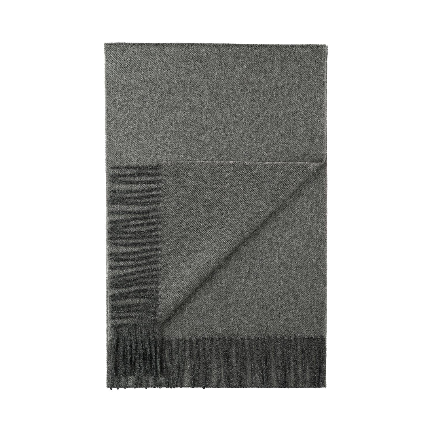 The 100% Baby Alpaca Scarf in Carbon exudes luxury, featuring a folded gray design with a striped pattern and fringe along one edge, crafted for a soft, elegant touch.