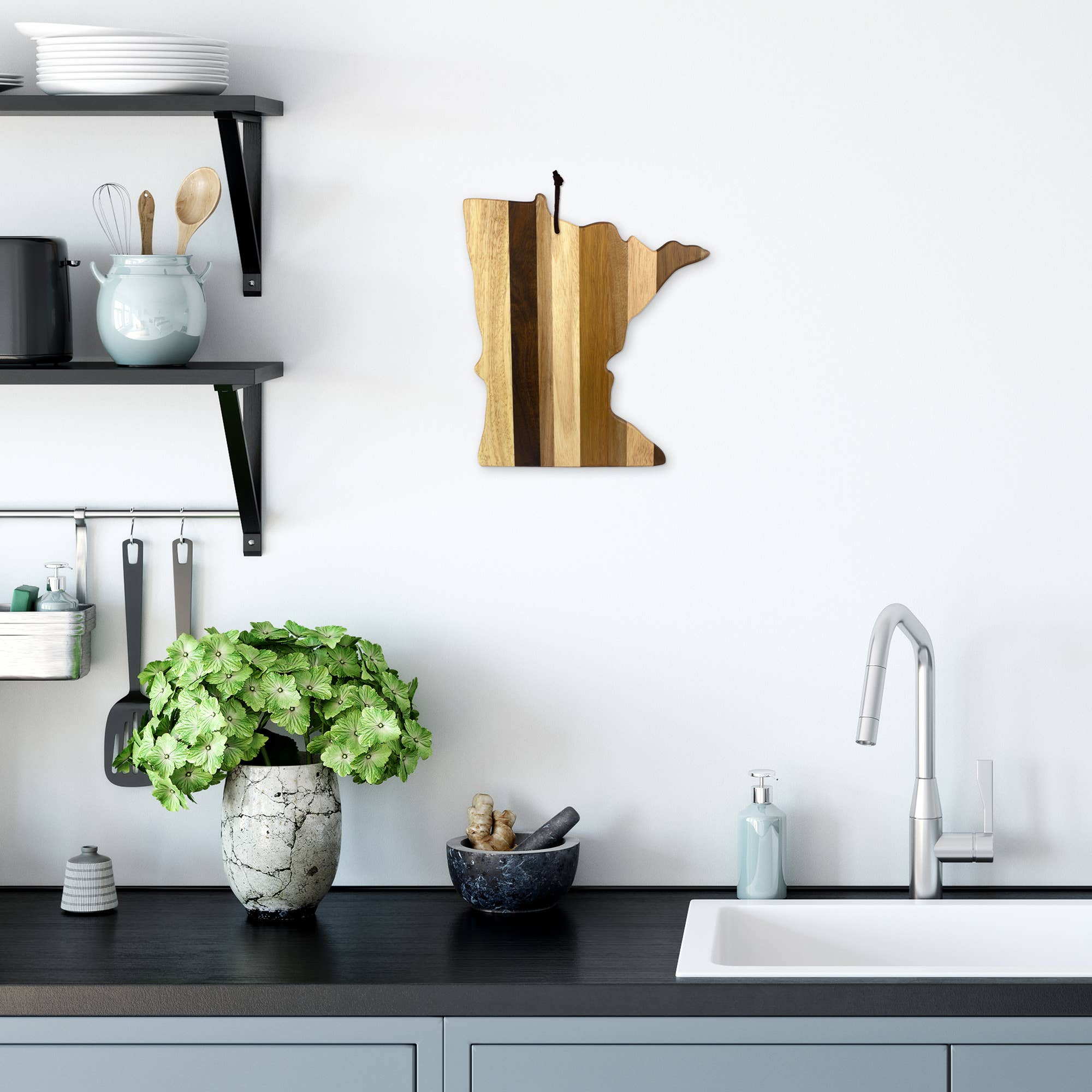 Modern kitchen with a plant on the counter, utensils on shelves, and the Minnesota Shiplap Series Serving Board hanging as charming wall decor above the sink.