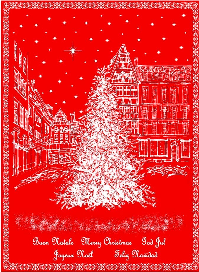 The Holiday European Village Woven Jacquard Tea Towel (20 x 28) features a festive town square Christmas tree scene with stars and Merry Christmas in multiple languages on red woven cotton.