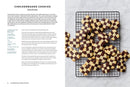 The recipe page from the book "Scandinavian from Scratch" showcases the art of Scandinavian baking, featuring checkerboard cookies on the left with detailed instructions and ingredients. On the right, a mouthwatering image displays freshly baked checkerboard cookies cooling on a wire rack.
