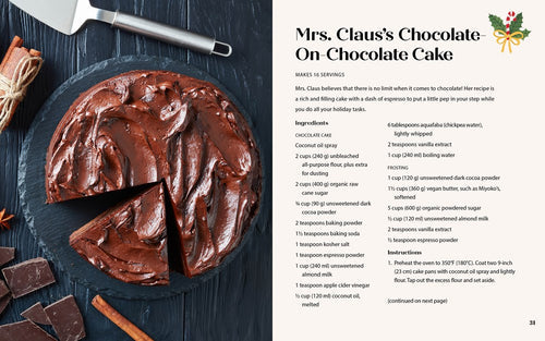 A chocolate cake with one slice missing sits on a dark surface. The *Cozy Christmas Cookbook 50 Recipes to Rediscover the Magic of the Season* by Taylor Vance features Mrs. Clauss Chocolate On-Chocolate Cake, offering a modern twist to holiday recipes. Nearby are a cake server and ingredients.