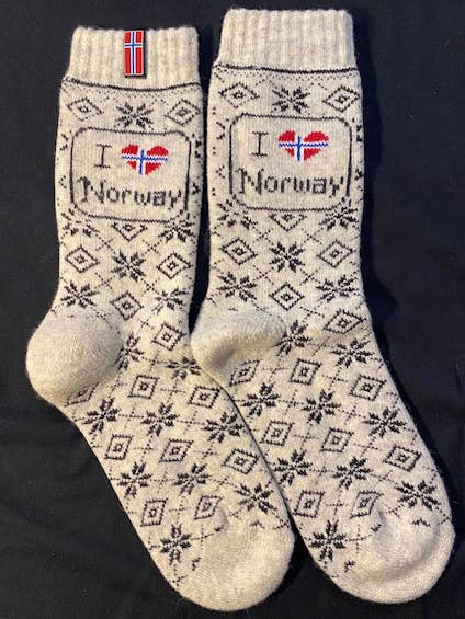 Wool socks with a Nordic pattern and “I ❤️ Norway” text, where the heart displays the Norwegian flag.