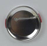 A back view shows the Humble Swede circle button with a pin clasp, featuring a metal design, set against a plain background.