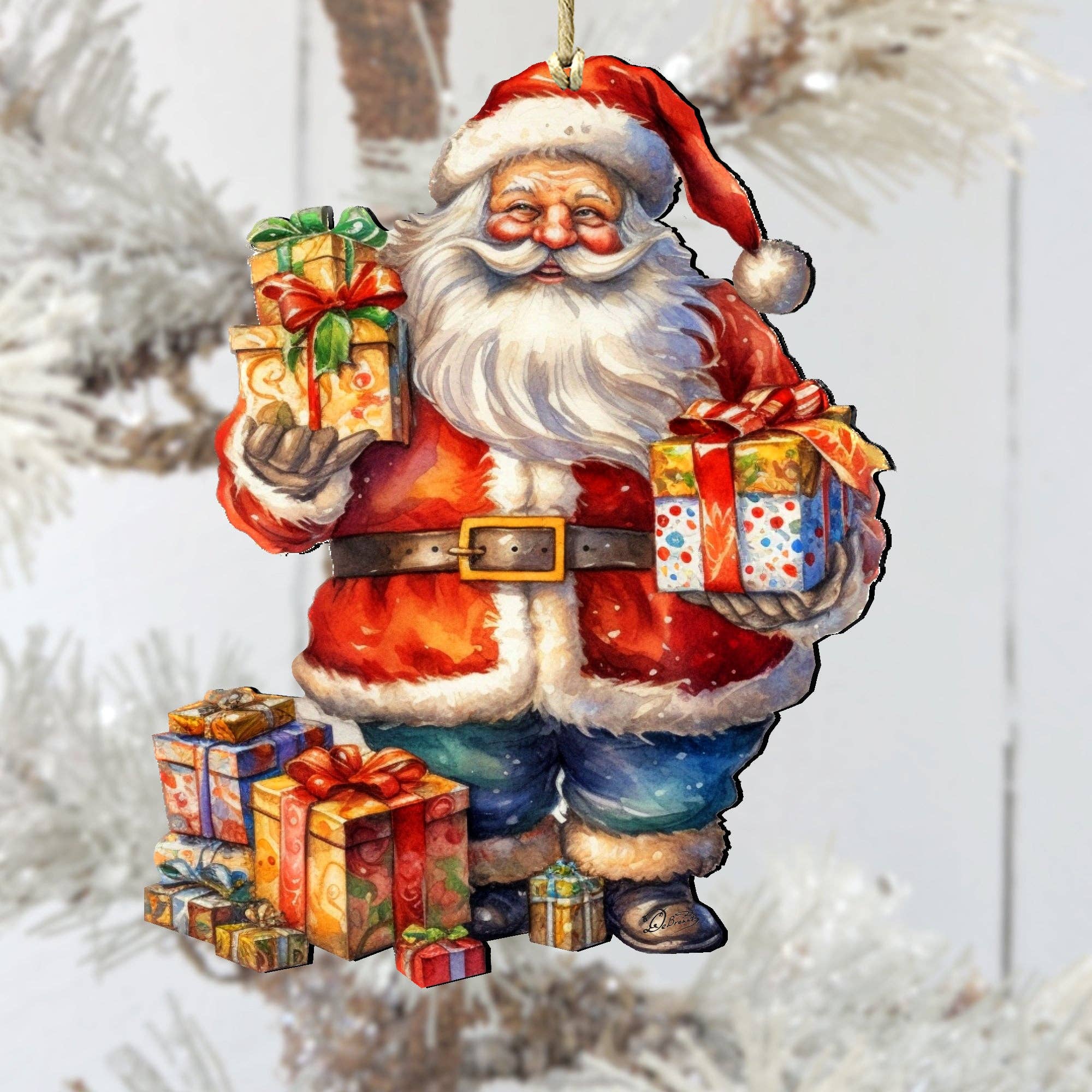 Illustration of the Merry Delivery Santa Wood Christmas Tree Ornament by artist G. Debrekht, showing Santa holding gifts with more at his feet, hanging on a frosted Christmas tree.