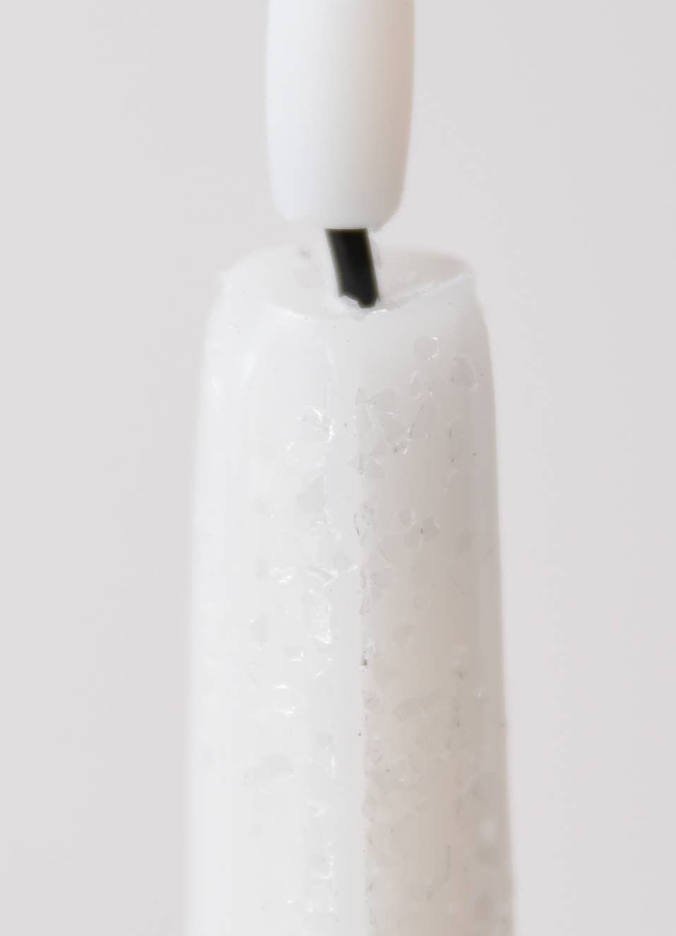Close-up of the Candle: Holiday Special Realistic Flame Battery Taper: Plain, with a visible black wick and white holder, showcasing its lifelike flame against a plain background.