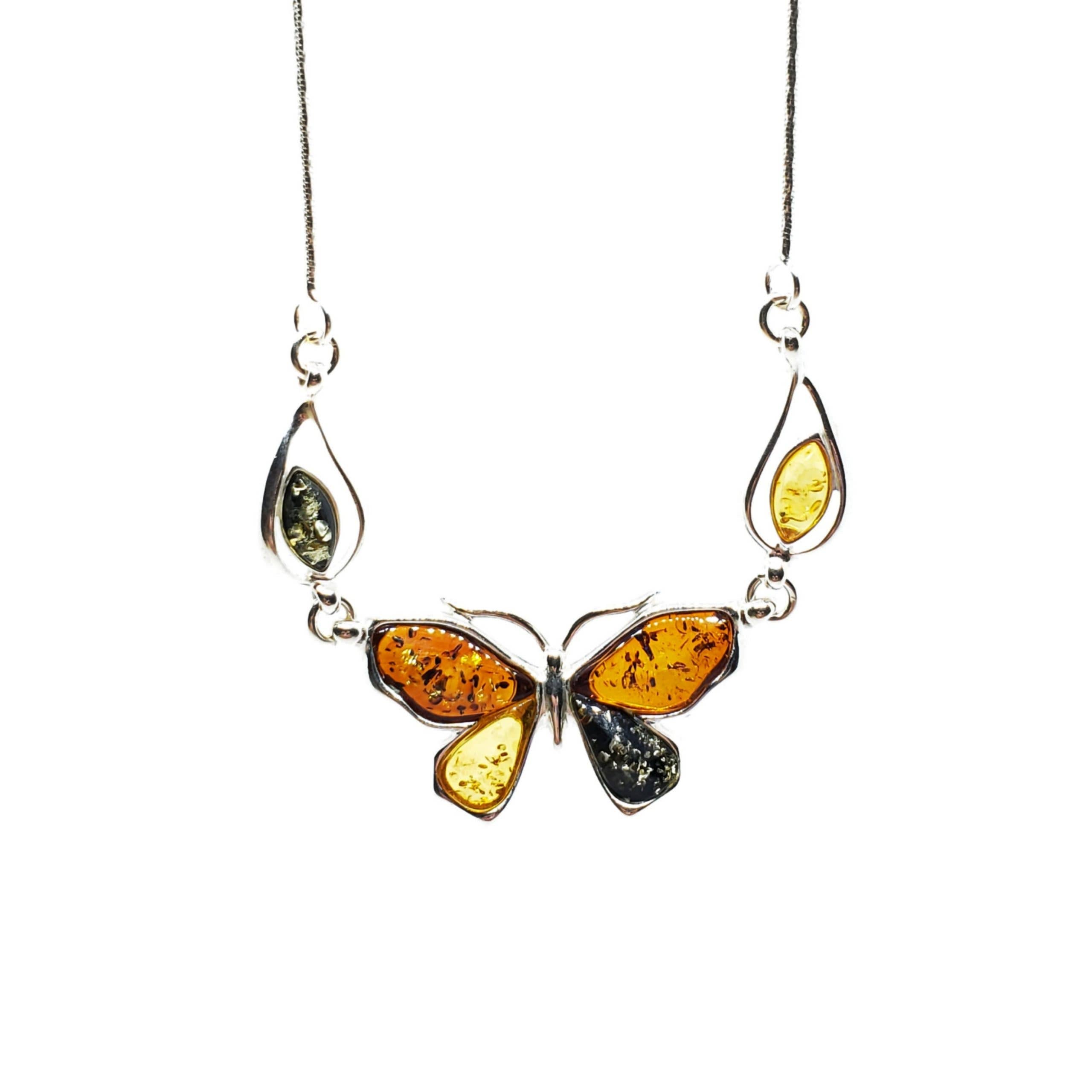The Butterfly Multi Color Amber Silver Necklace features a sterling silver pendant with multicolor amber and green gemstones, accented by two teardrop-shaped gems, on an 18 delicate chain.