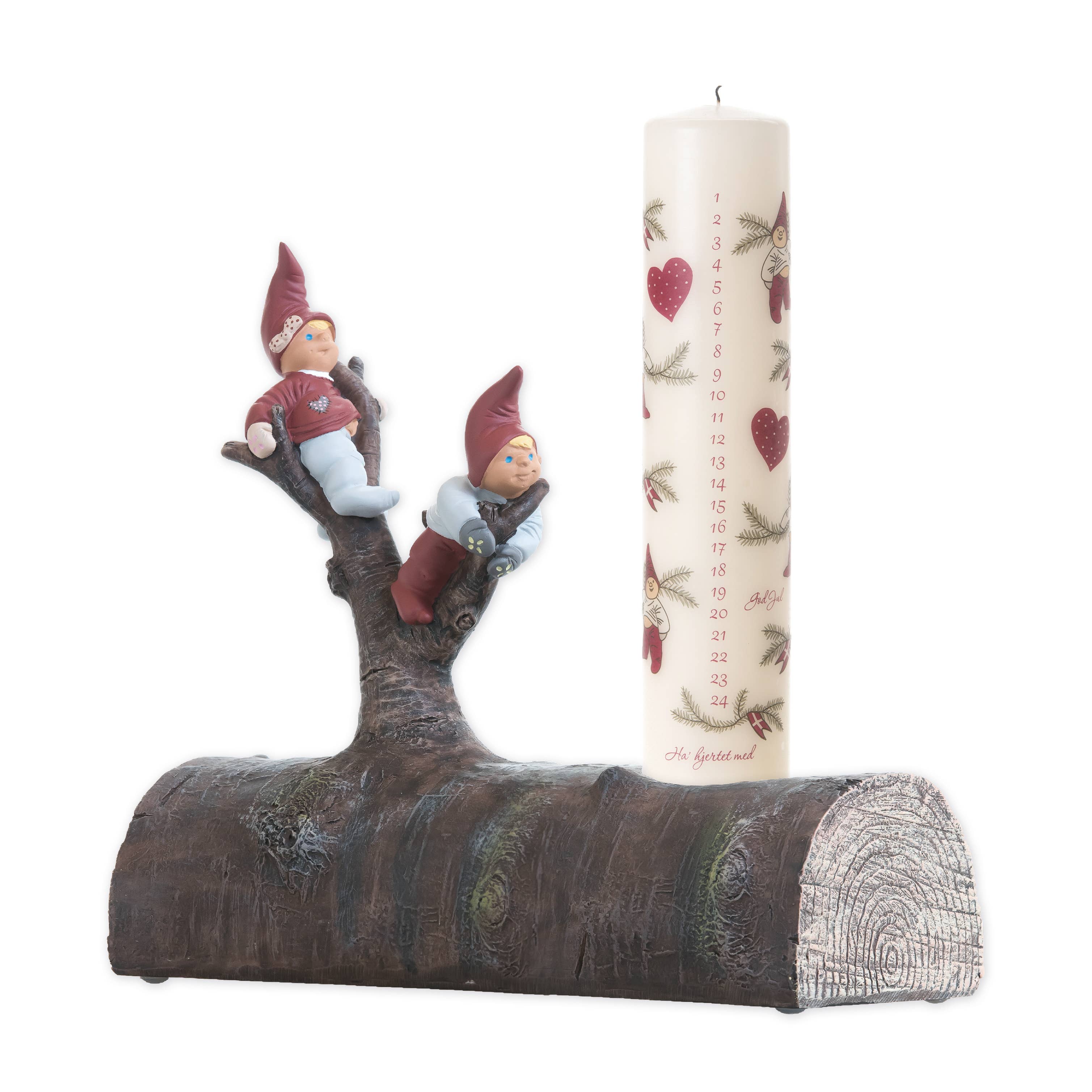 The Tue & Trille Calendar Candle Holder features a numbered countdown and heart design on a faux log, displayed beside two Danish Christmas gnome figurines resting on a small tree branch.