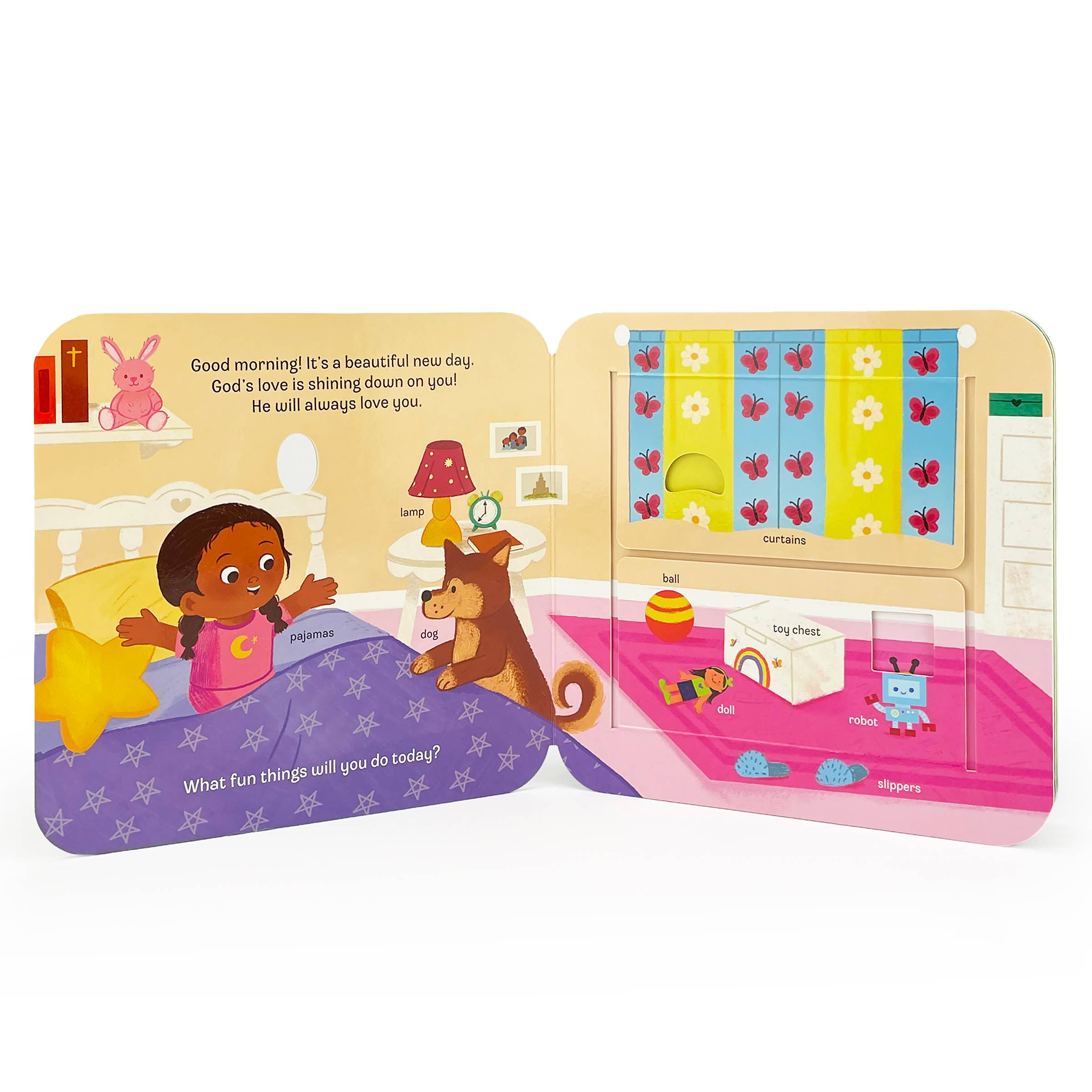 The "God Lift a Flap Board Book" features toddler-friendly illustrations of a girl and her dog waking up, with labeled items like lamp, slippers, curtains, and toys, welcoming the day and highlighting God’s love.