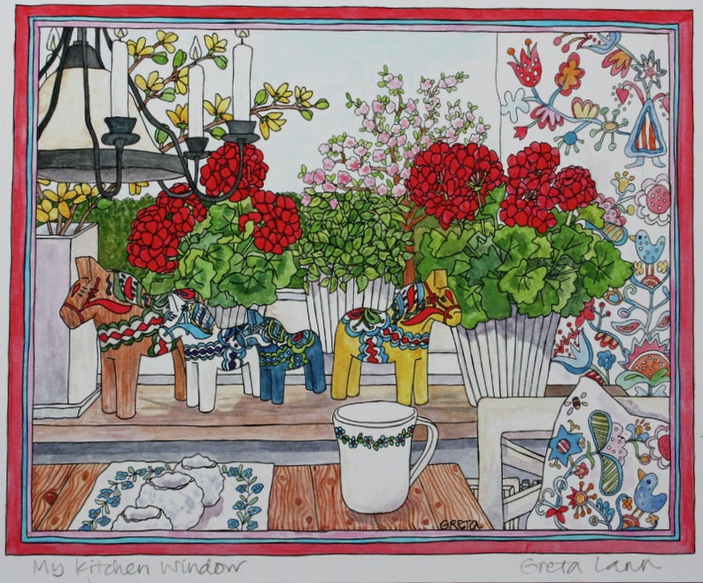 A charming 11x14 autographed print, "My Kitchen Window" by Greta Lann, features red geraniums, Dala horses, a white mug, floral pillow, patterned wallpaper, and tablecloth in a cozy Swedish kitchen scene.