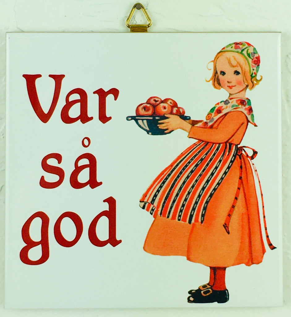 Decorative 6 ceramic tile features a Swedish girl in traditional dress holding apples beside Var så god, meaning You are welcome in Swedish.