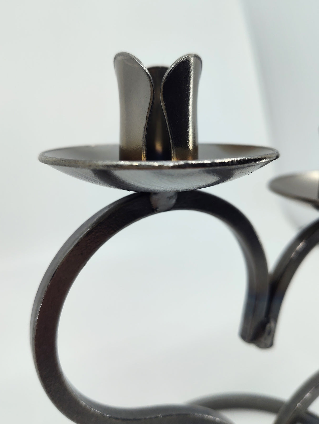 Close-up of a Danish Iron Taper Candleholder with large heart for 2 taper candles, featuring a minimalist design reminiscent of Danish craftsmanship, set against a plain white background.