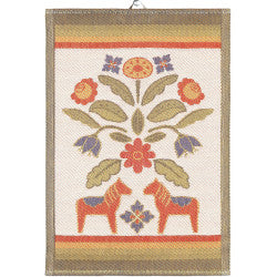 The Tea Towel: Kurbitsblom showcases an embroidered design with two orange dalahorses, flowers, and leaves made from organic cotton. It is highlighted by green, red, and tan borders.