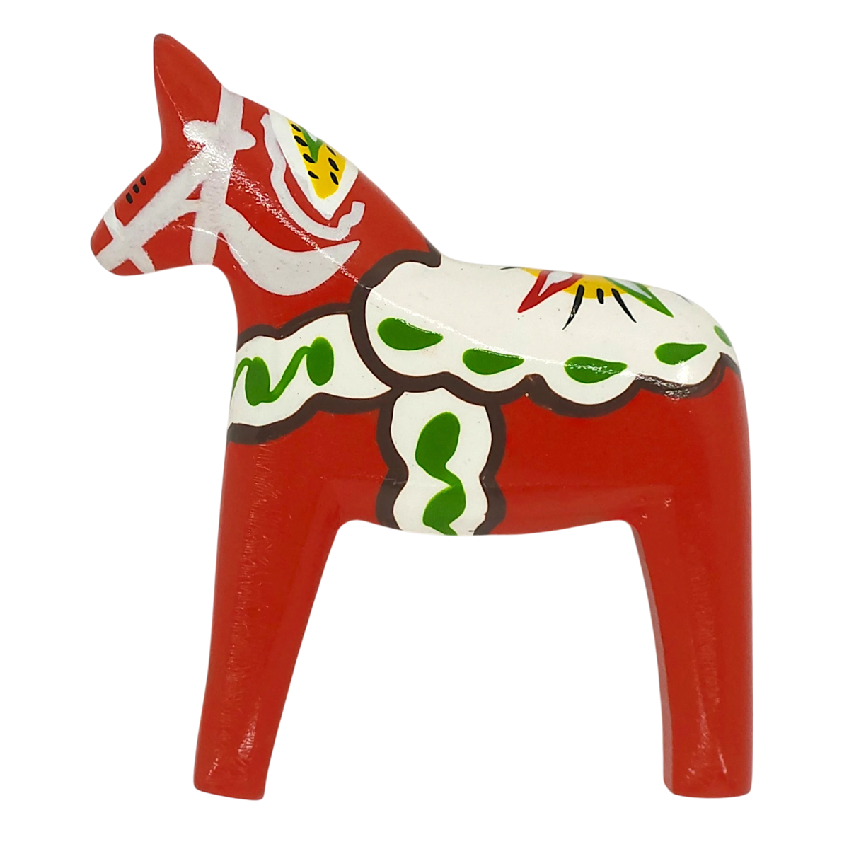 A red Dala Horse magnet with white, green, yellow, and black decorative patterns stands on all four legs against a plain white background.