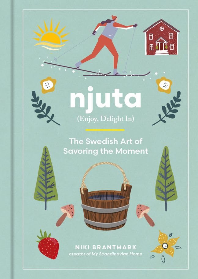 Book cover with a skier, red house, flowers, basket, mushrooms, and leaves. Title text includes “njuta” and references the Swedish art of savoring the moment.