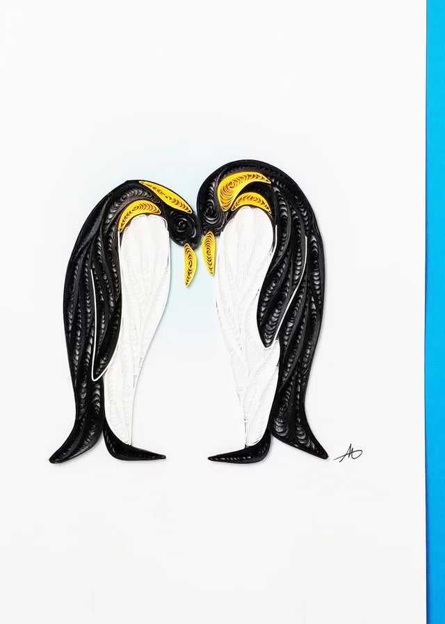 The Cards: Penguin Couple Quilling Card showcases two penguins facing each other, crafted from black, white, and yellow paper strips on a white background with a blue edge.
