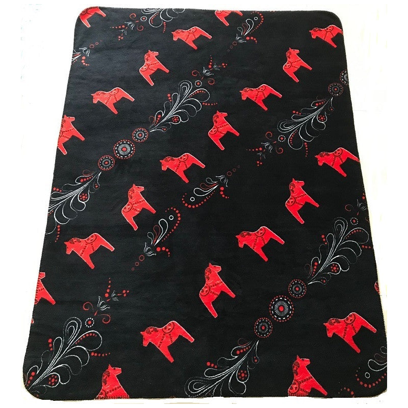 Red and black fleece blanket adorned with intricate Kurbits patterns and Dala horse motifs.