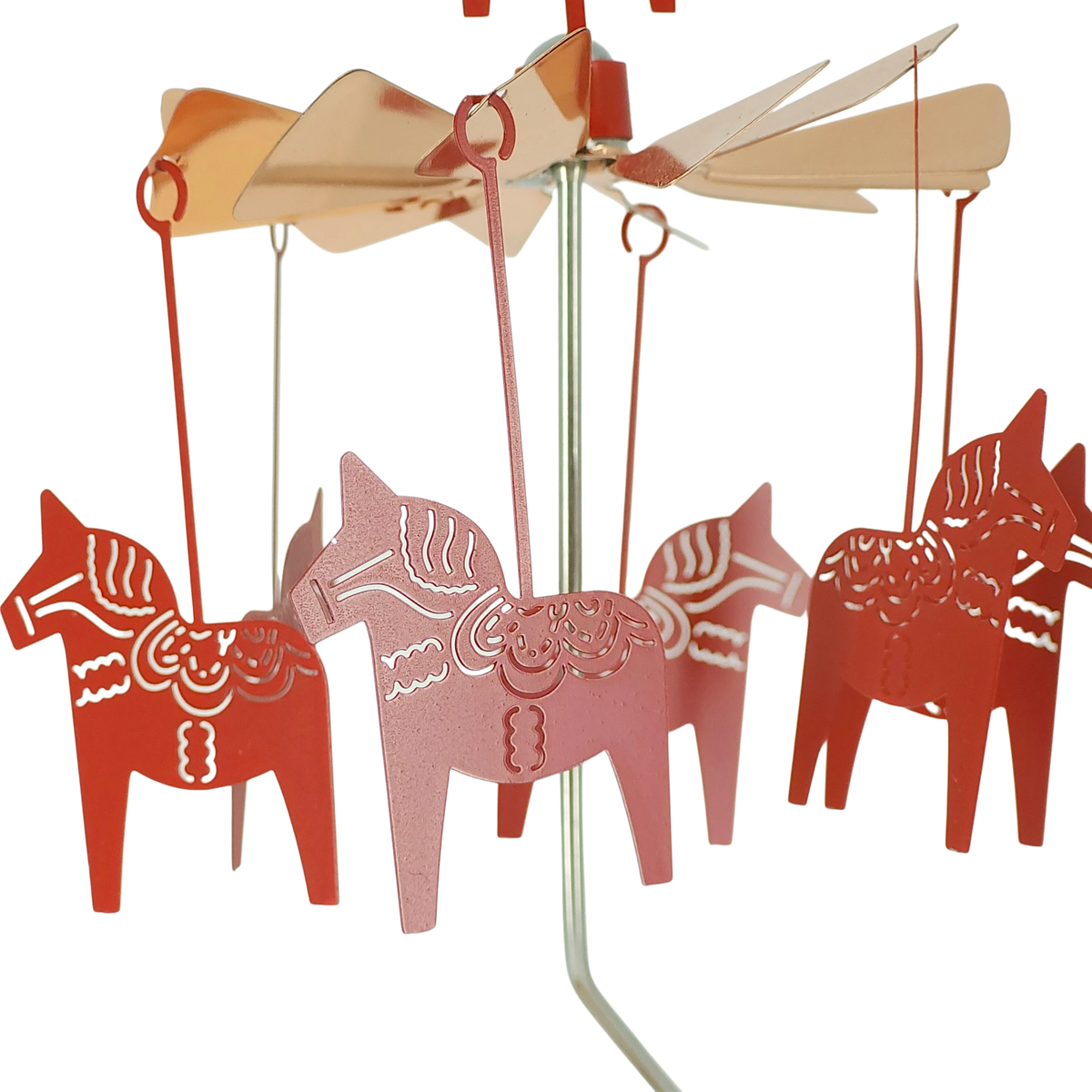 Rose gold Dala horse figures suspended from a circular metal mobile with a central pole, arranged evenly in a Scandinavian-inspired design.