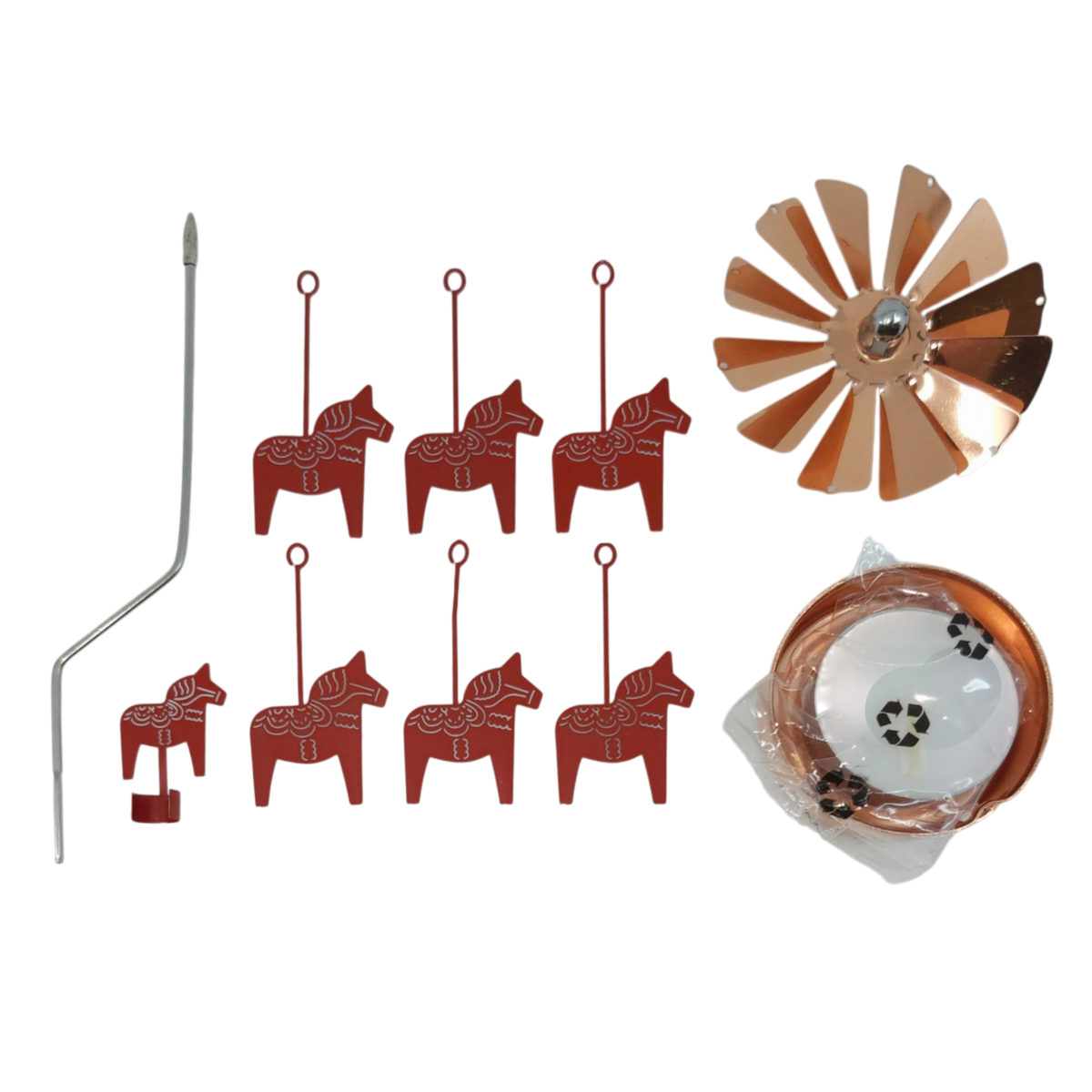 Six red Dala horse ornaments, a bent metal rod, a copper wind spinner, and a coiled copper strip arranged on a white surface.