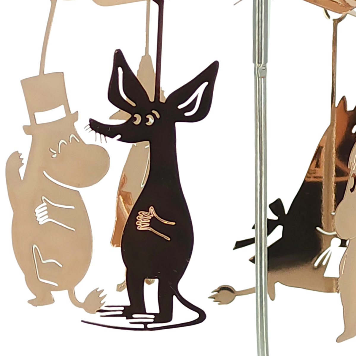 Metal cutouts featuring a top-hatted Moomin character and a black dog-like figure hanging from a reflective rod.