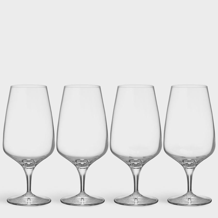Four clear Orrefors Pulse Beer Glasses (18.5oz, 4-pack), designed by Ingegerd Raman, showcase Scandinavian simplicity as they stand in a row against a plain white background.