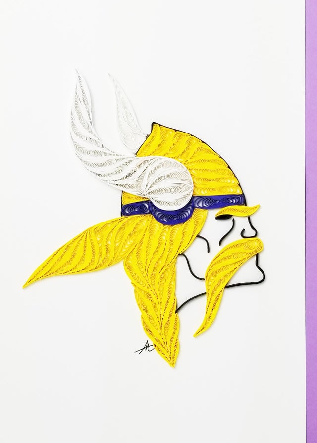The Cards: Minnesota Viking Quilling Card 5x7 showcases handmade quilled paper art of a Viking head with a yellow helmet, white horns, and yellow mustache, set on a white background with a bold purple border.