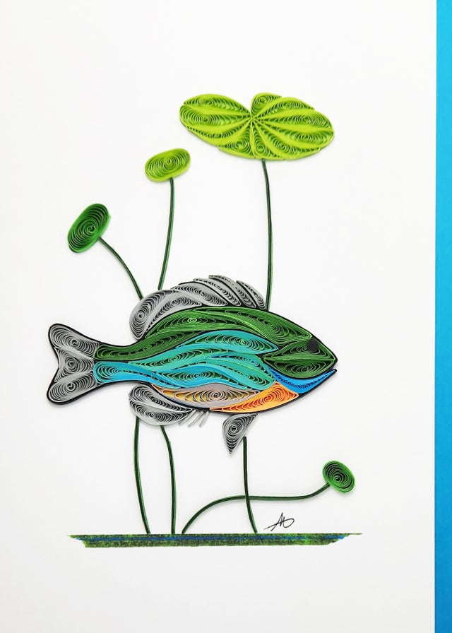 The Cards: Bluegill Fish Quilling Card 5x7 features hand-crafted quilled art of a Bluegill Fish and three lily pads on white with a blue border, perfect for celebrating Minnesota’s lakes.