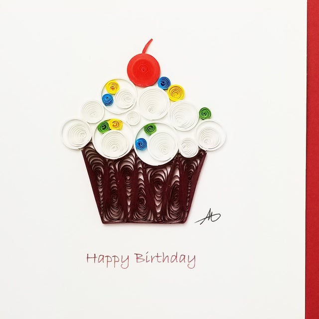 The Cards: Cupcake "Happy Birthday" Quilling Card 4x4 features a handcrafted paper quilled cupcake with a cherry on top, centered on white with "Happy Birthday" in red below.