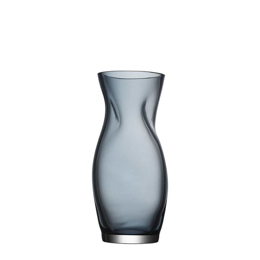 The Orrefors Squeeze Blue/Gray Vase Small by Lena Bergström is a sleek masterpiece, featuring a translucent blue hue and curvy silhouette that create a striking presence against the white background.