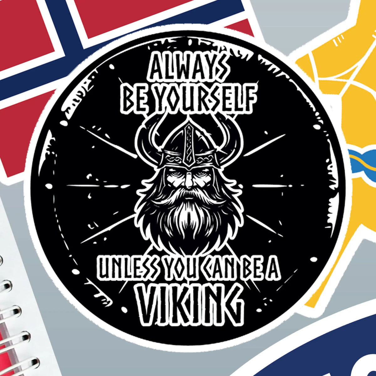Round sticker showing a bearded Viking warrior in a helmet with the text: Always be yourself unless you can be a Viking. Flags and a notebook are visible in the background.