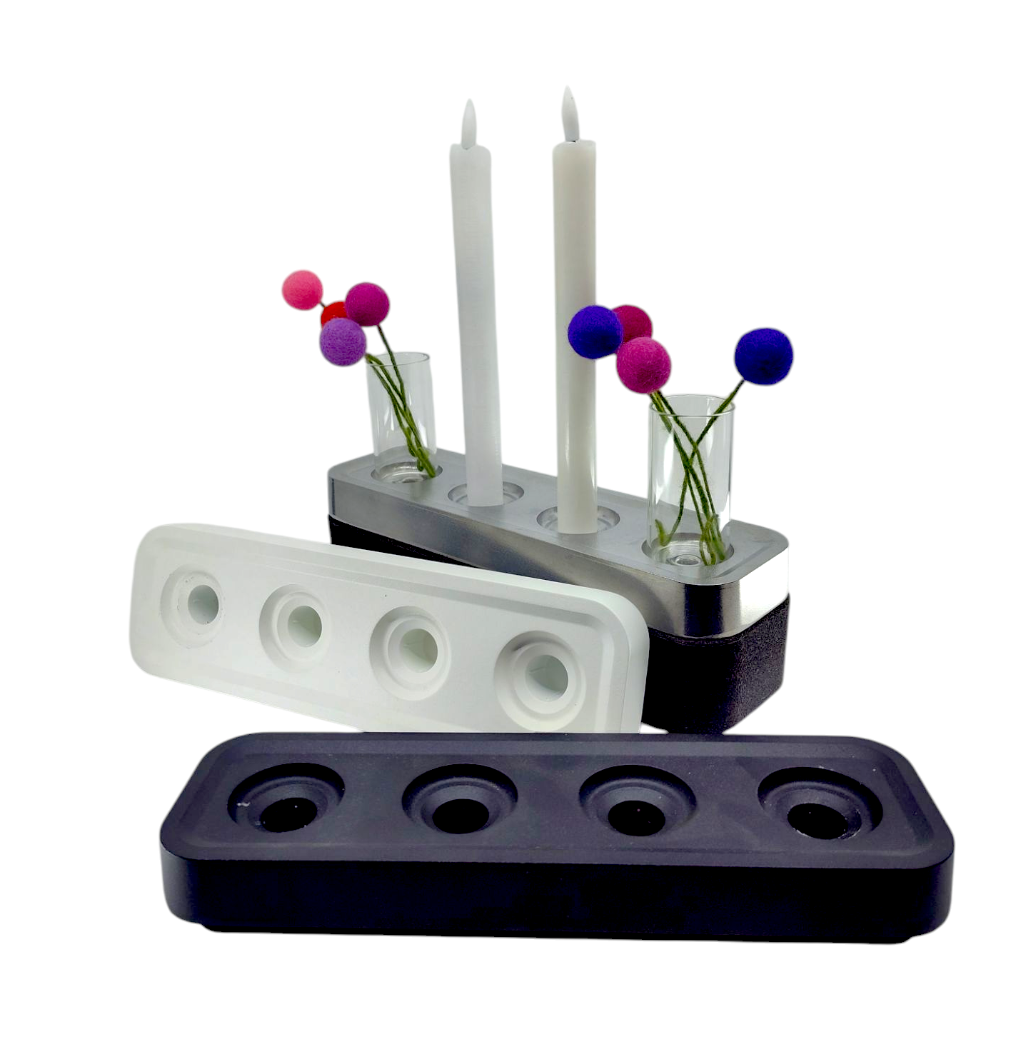 The Candleholder: Stumpastaken Swedish Candle Holder comes in black and white, featuring a top with four slots for two candles and vases. Decorated with colorful pom-poms, it combines elegance with an eco-friendly design.