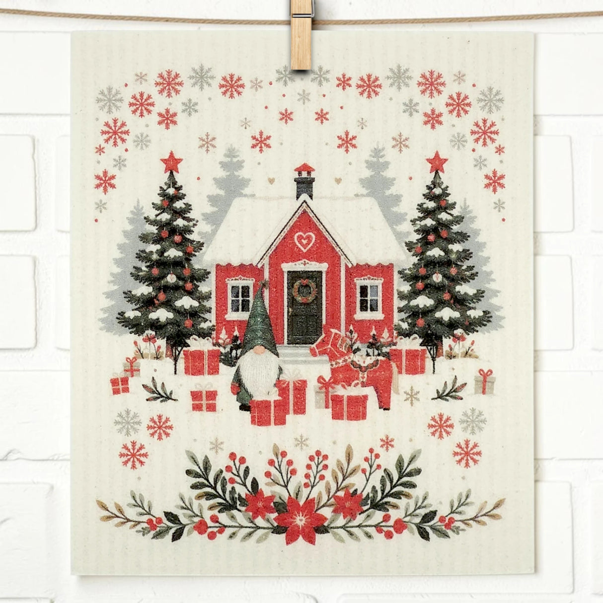 Scandinavian-style design featuring a red house with snow, two Christmas trees, gifts, a gnome, reindeer, and red flowers on the product.