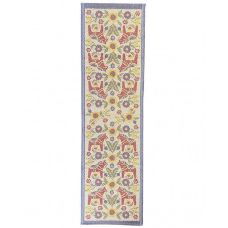 The Kurbitshast Flower Horse Table Runner by Ekelund Master Weavers is a long, narrow rug with a floral pattern in red, yellow, blue, and green on a light background with a blue border, crafted from eco-cotton.