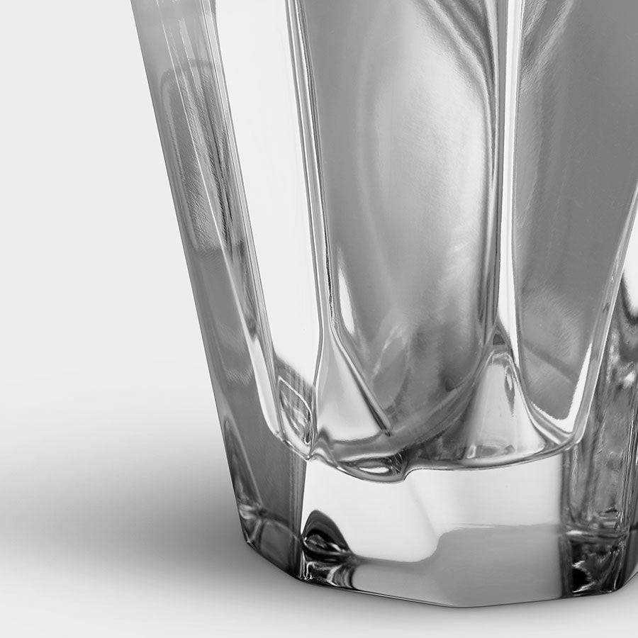 The close-up showcases the Orrefors: Precious Vase Small, a clear, empty glass with a geometric pattern reminiscent of Malin Lindahls intricate designs, set against a plain background.